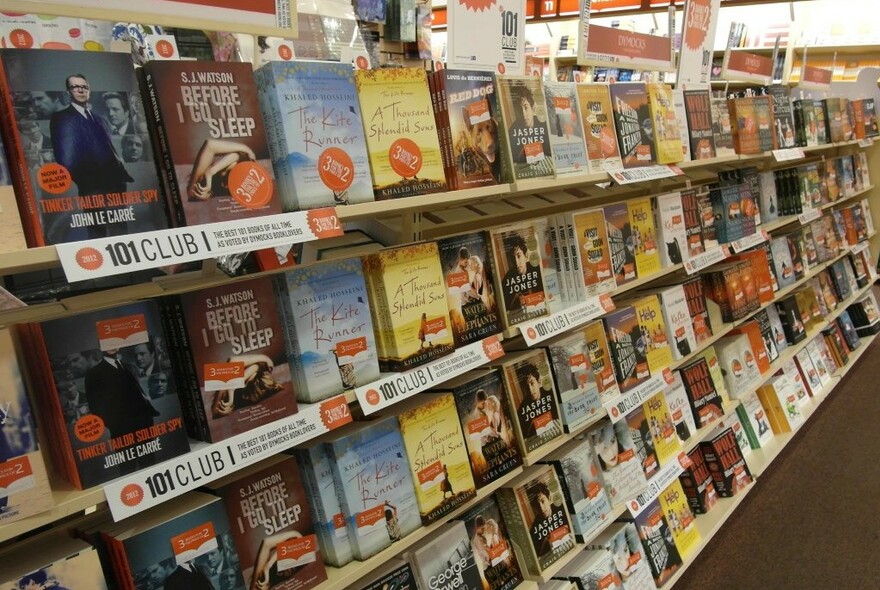 Books for sale on shelves of Dymocks bookshop.