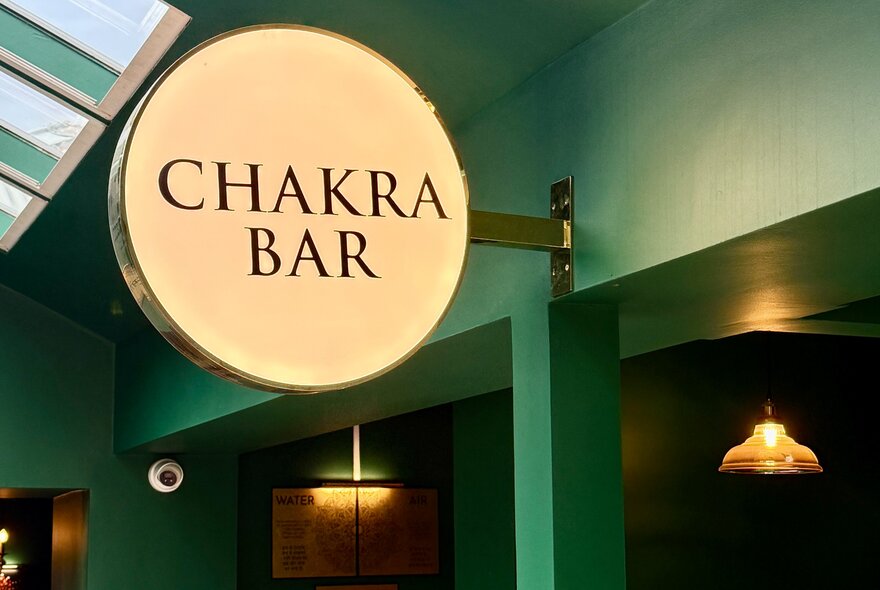 Venue interior with overhead lighting and signage.