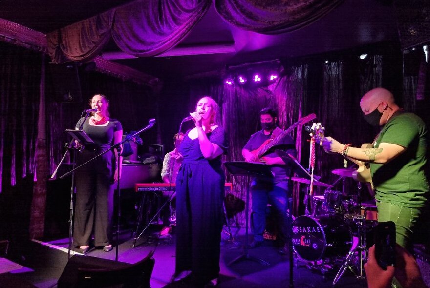 Band performing on a small stage.