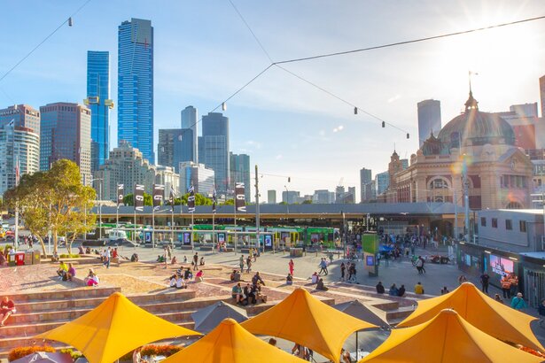 Federation square on a sunny day overlooking Flinders Station and the city skyline