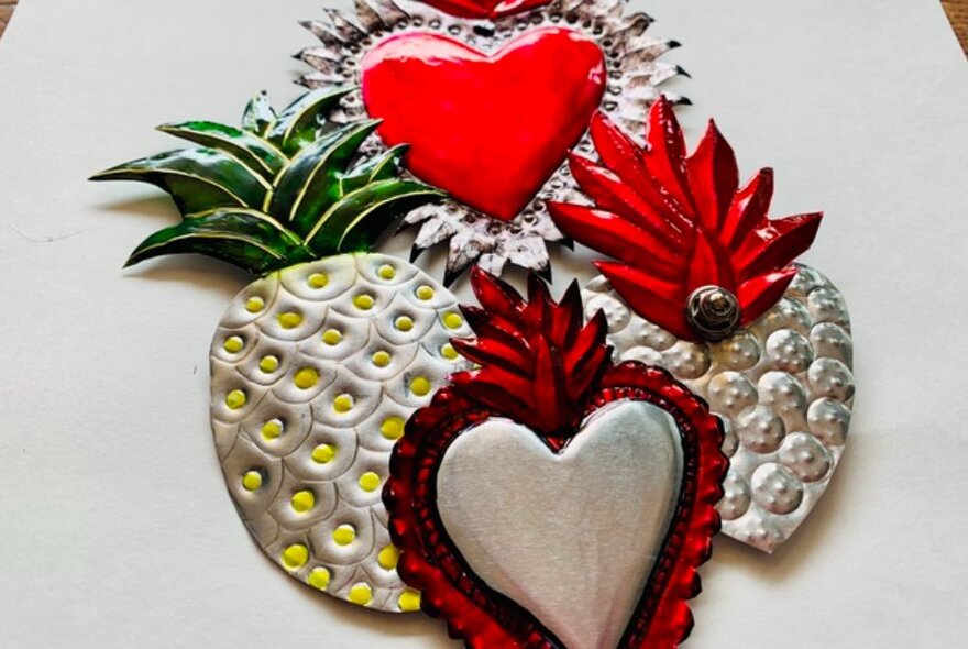 Pressed-tin decorations including hearts and pineapples.