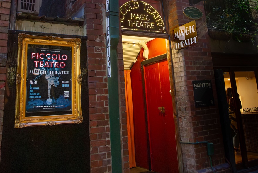 A red doorway with a sign for Piccolo Teatro. 