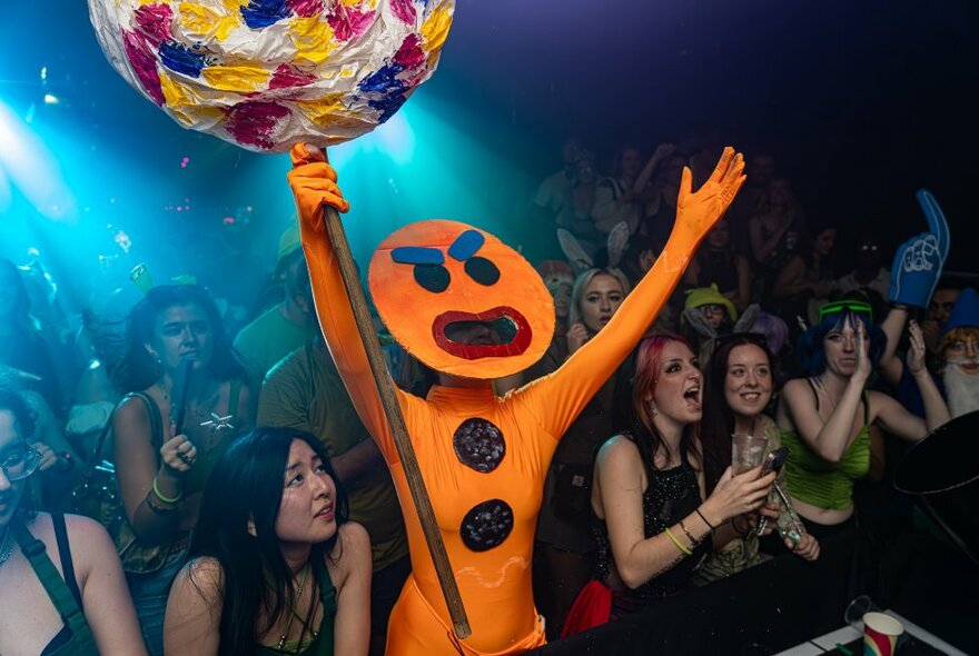 Nightclub audience with Shrek character in the front row.