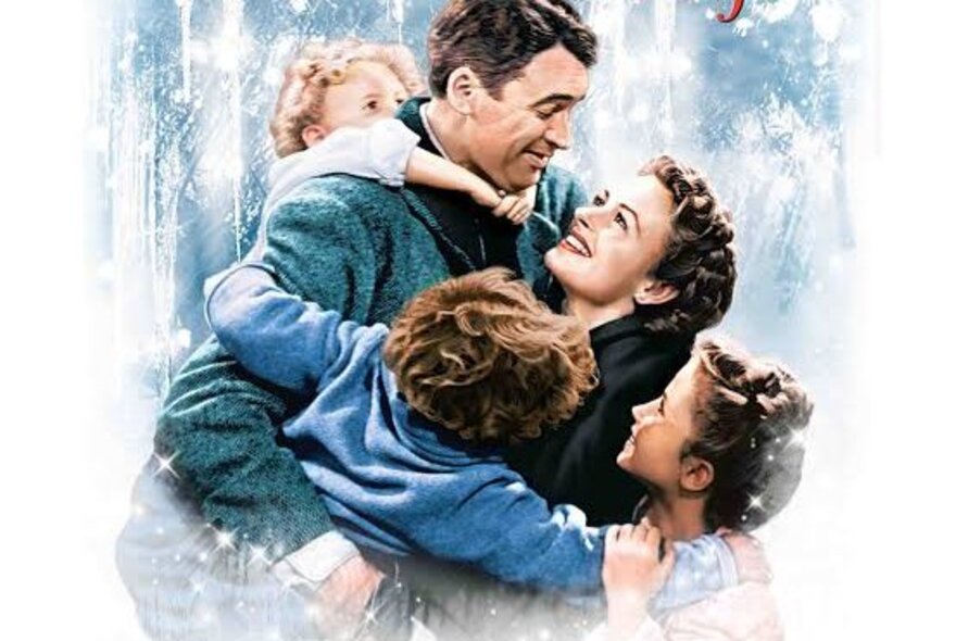 A promotional shot for the movie, It's a Wonderful Life, with a family enjoying a hug together in the snow.