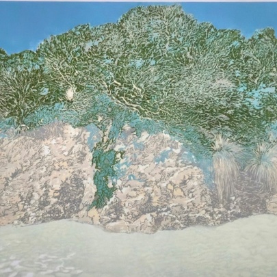 A mixed-media artwork depicting a rocky coastline with green foliage under a blue sky.