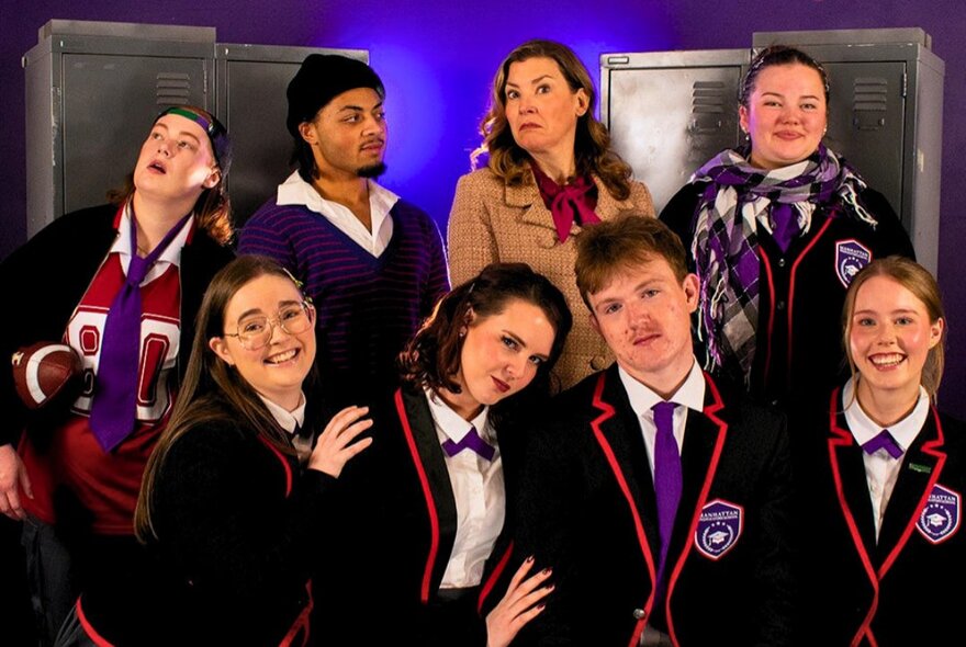 Six students in school uniform and two teachers all together in a group shot.