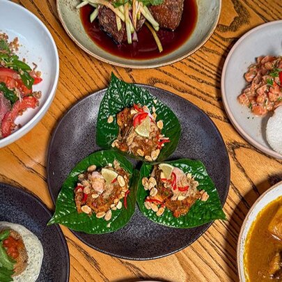 A table set with Asian fusion dishes.