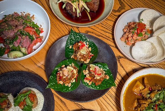 A table set with Asian fusion dishes.
