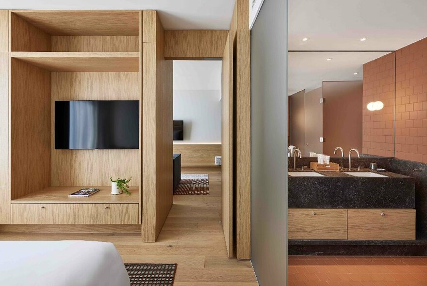 An internal view of a hotel room in the Hyatt Centric Melbourne, showing a luxurious bathroom and wooden joinery in the main room.