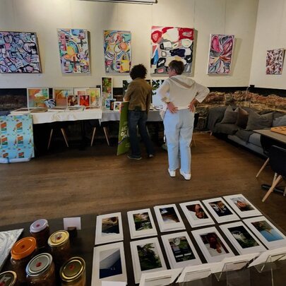 Large room with artwork on walls and floor.