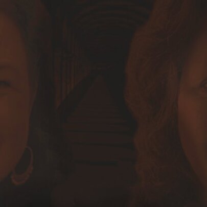 A dull brown image of two women's faces, both smiling.