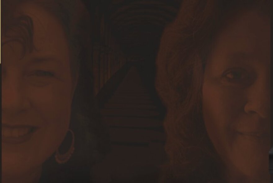 A dull brown image of two women's faces, both smiling.