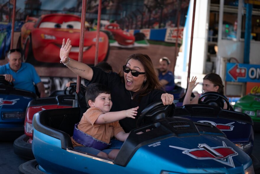 Child and adult in a dodgem car.
