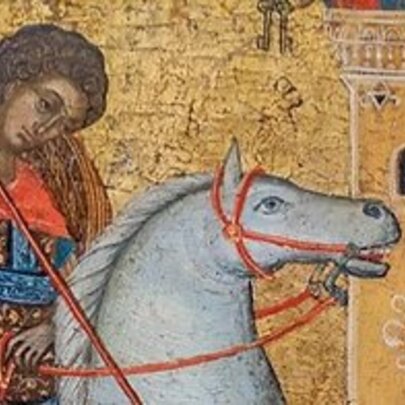Crusader on a white horse outside a golden tower.