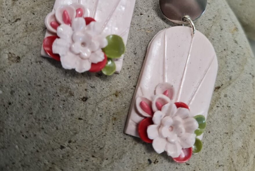 A pair of floral designed polymer clay earrings.