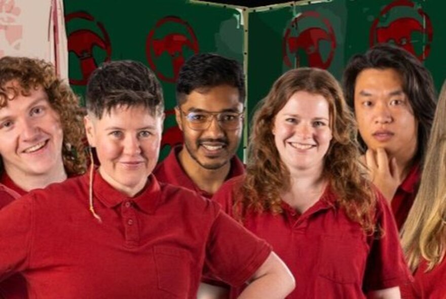 Five impro theatre performers, all wearing red polo shirts, posed in front of a green backdrop with the Bunnings hammer logo just visible.