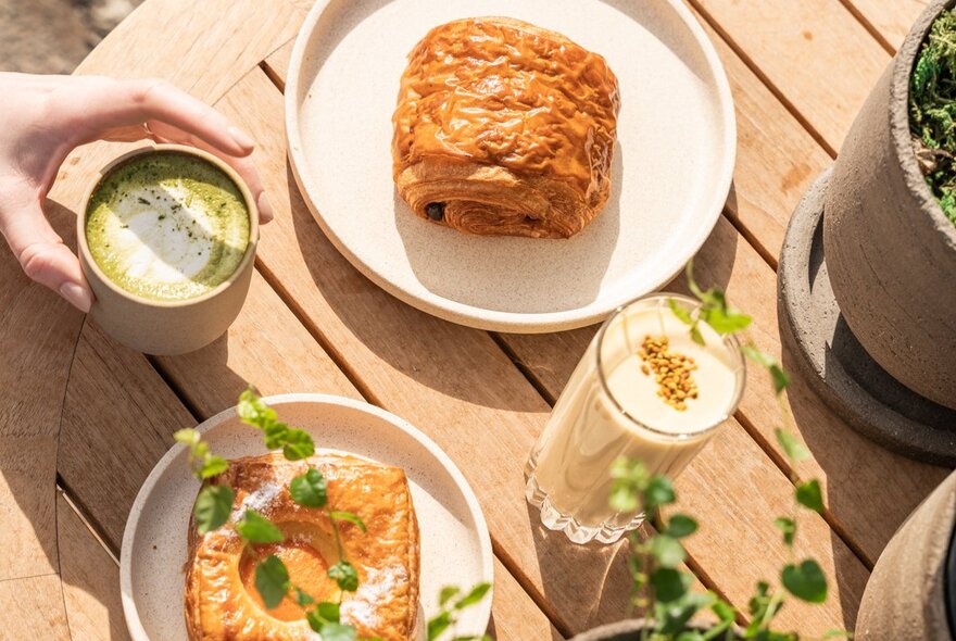 Looking down on a table with matcha tea and pastries.