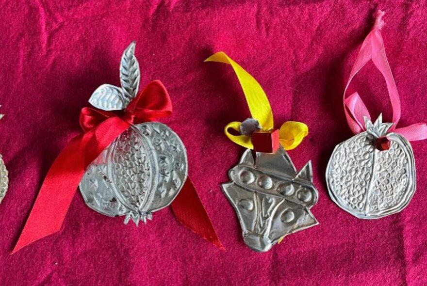 Metal Christmas decorations with ribbons.