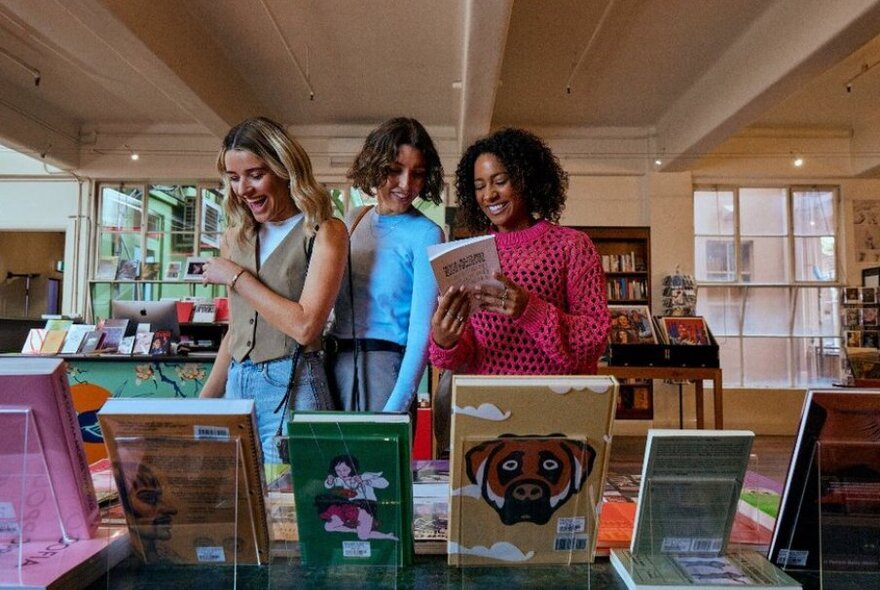 Three people shopping at a bookstore