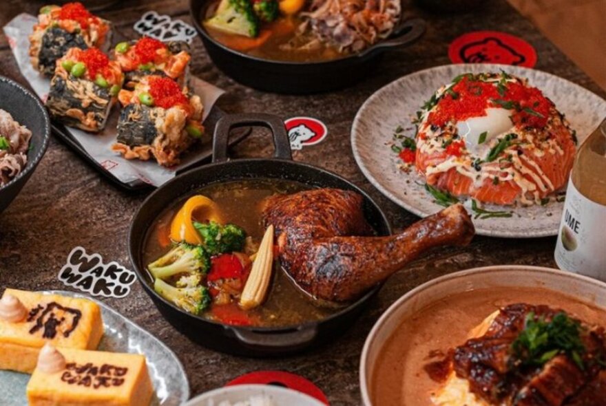 Different dishes of Japanese food arranged on a table in a restaurant.