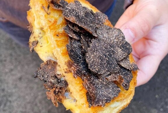 Toasted cheese sandwich topped with freshly shaved truffles.