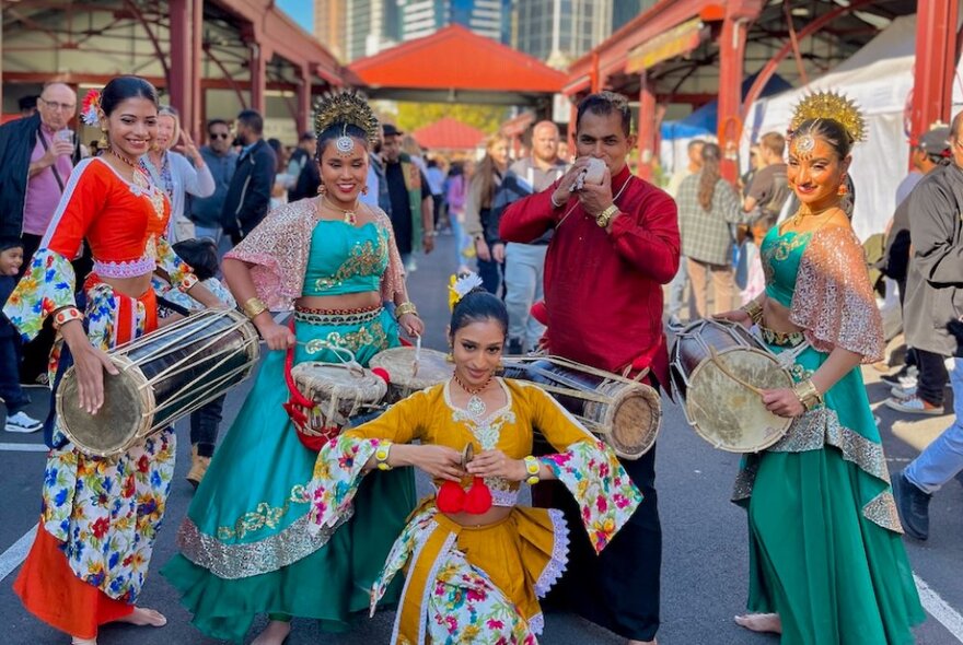 People in Sri Lankan traditional dress playing instruments at the Queen Victoria Market. 