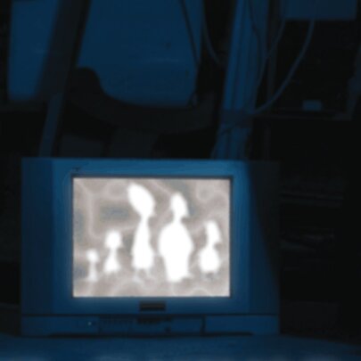 A vintage television set placed in a dark environment, displaying a glowing abstract light silhouette image of several rounded, organic figures on screen.