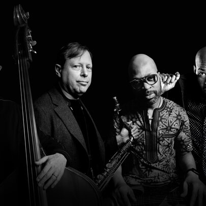 Four jazz musicians with their instruments.