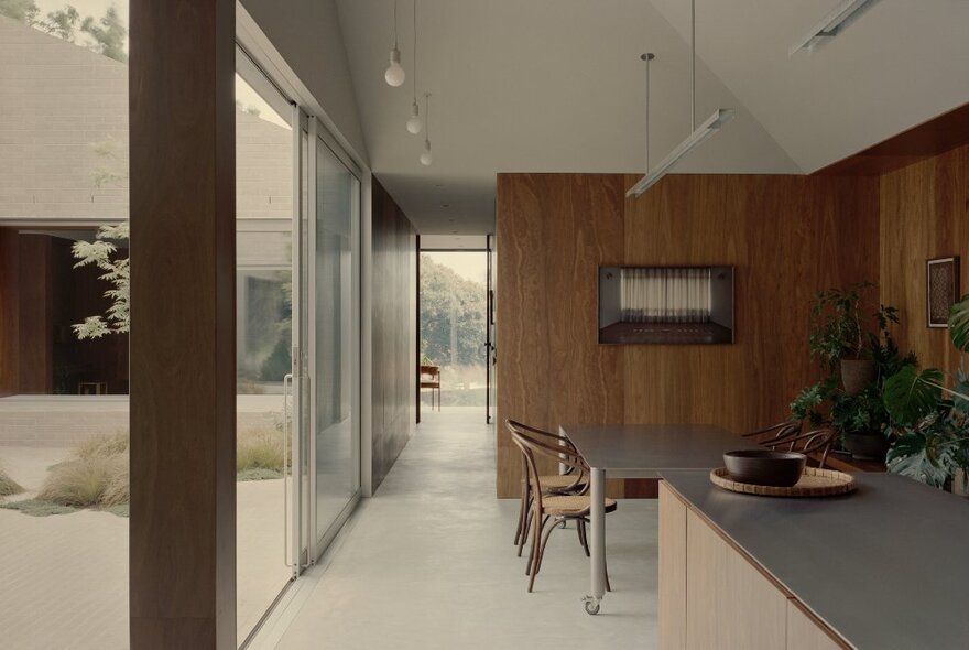 Interior of a Robin Boyd house with wood panelling a long hallway. 