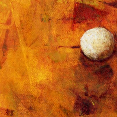 Artwork showing orange and yellow tones of abstract paint with a small white ball lodged into the painting. 
