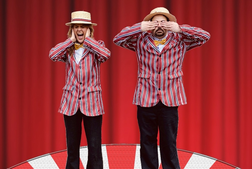 Man and woman on a stage, wearing matching striped jackets, straw boaters, and black pants, the woman with her hands over her ears and the man with his hands over his eyes.