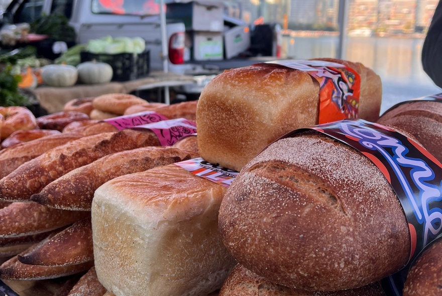 Fresh bread and baguettes for sale at a stall at a Farmers' Market.