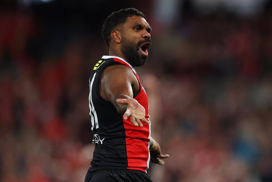 A St Kilda AFL player celebrating a goal during a game.