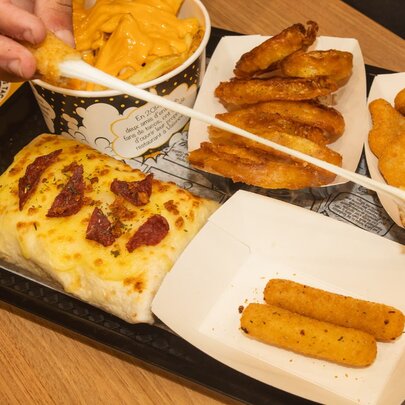 A fast-food sharing platter from Chamas Tacos featuring their cheesy filled tacos, and fries. 