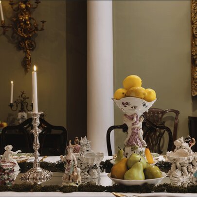 Georgian antiques decorating a dining table, including candlesticks and ornaments.