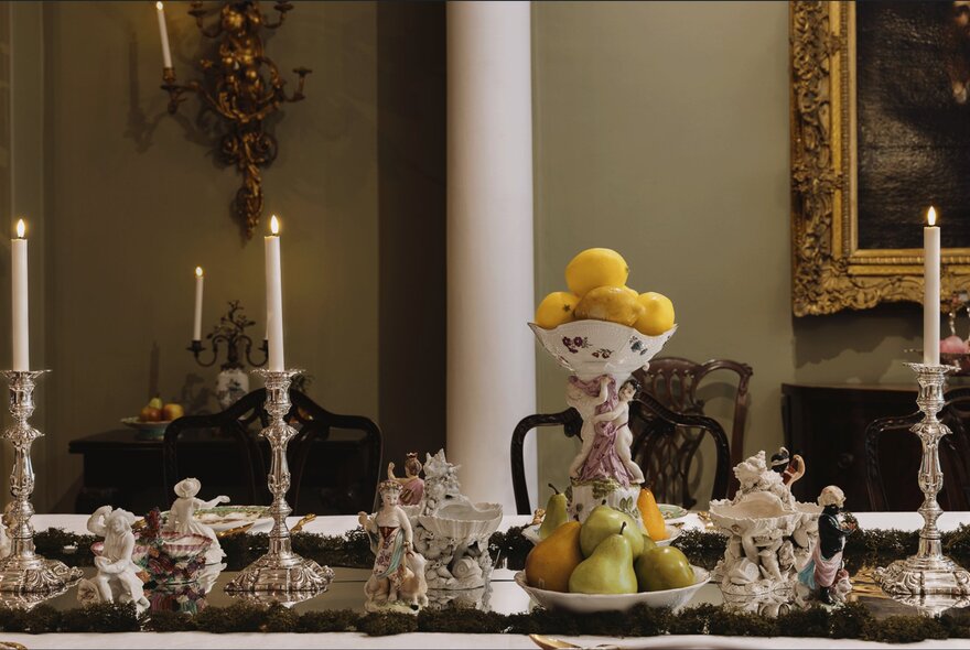 Georgian antiques decorating a dining table, including candlesticks and ornaments.