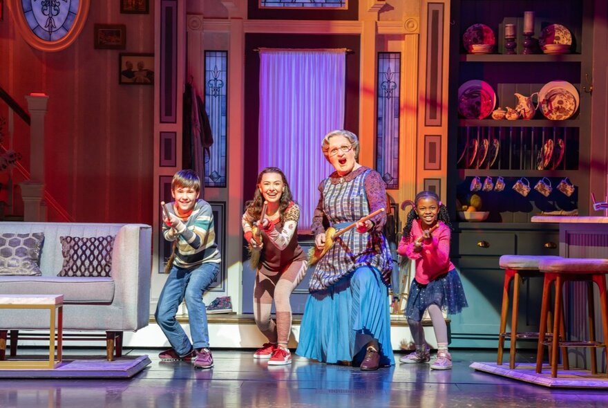 A scene from Mrs Doubtfire The Musical with the protagonist dancing with three children. 
