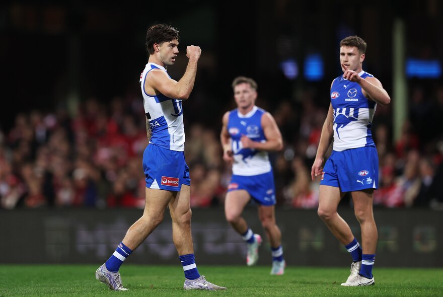 North Melbourne AFL football players on the field during a match.
