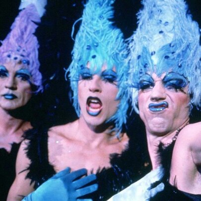 Three actors in character and full drag costumes from the film The Adventures of Priscilla, Queen of the Desert