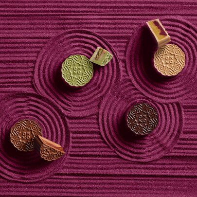 Four different coloured mooncakes.
