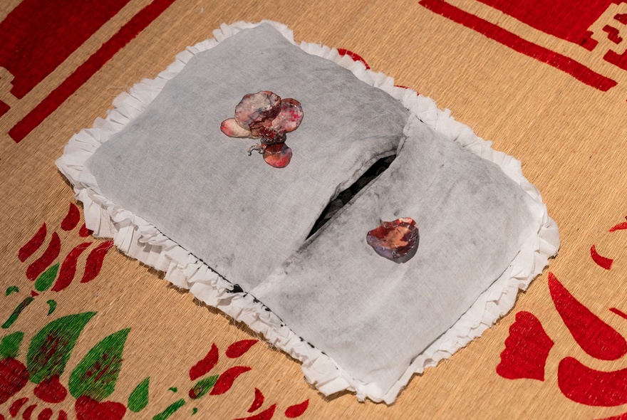 Decorated napkin on a printed woven mat.