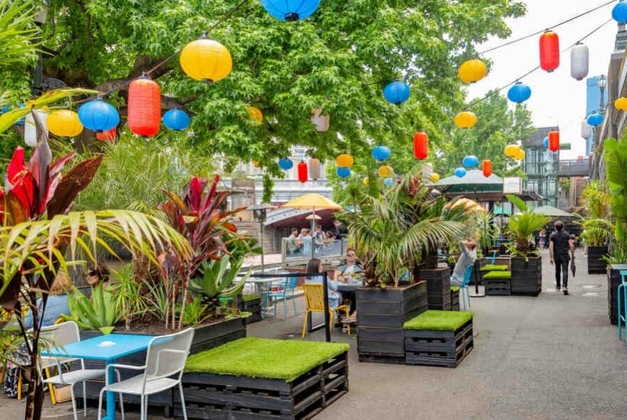 A beer garden with hanging paper lanterns