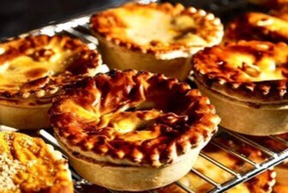 A tray of crispy pies on an oven shelf.