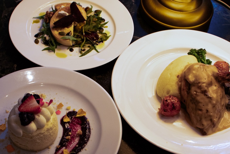 Artfully arranged dishes of food on white plates.