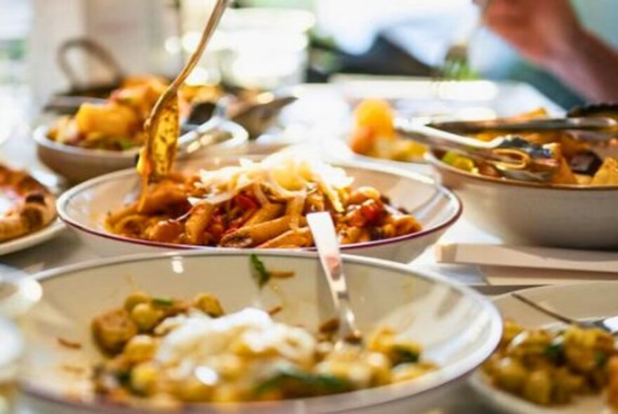 Bowls of pasta on a table.