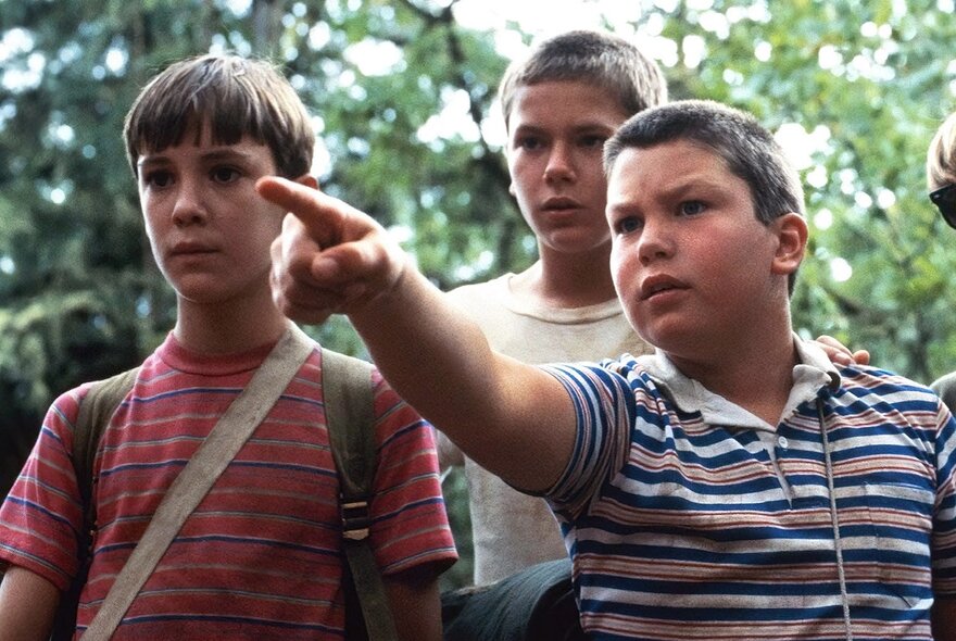 Three young boys in a film still from Stand By Me.