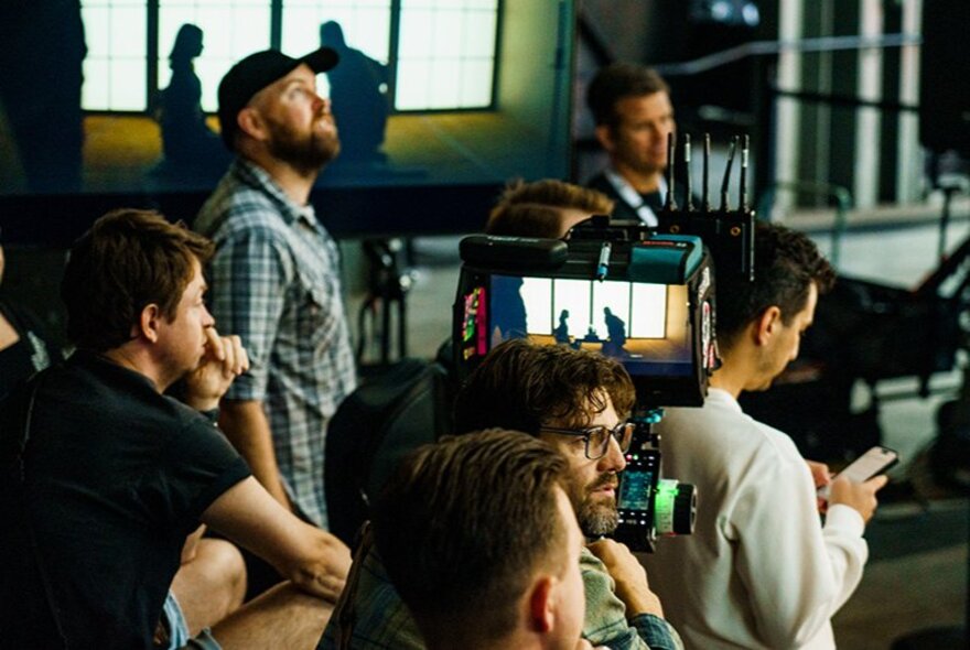 A demo of professional camera gear at the Sony SceneScape expo with several people standing around and engaging with video production equipment.