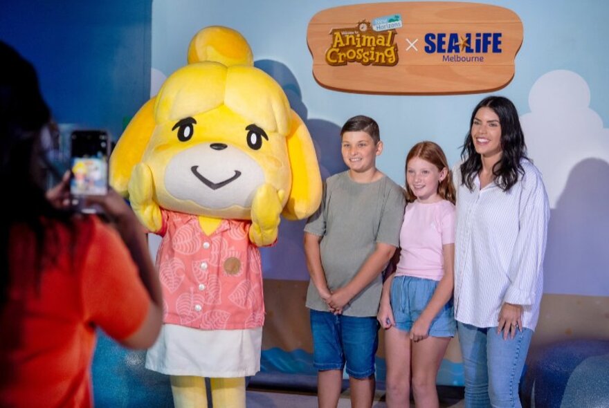 A family posing for a photo with a character from Animal Crossing: New Horizons.
