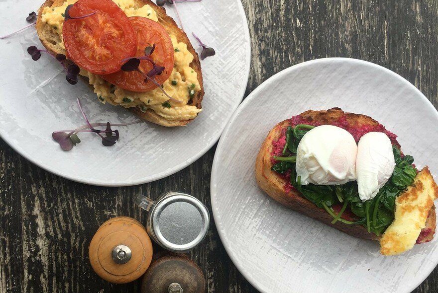 Poached eggs on toast with tomatoes and spinach.