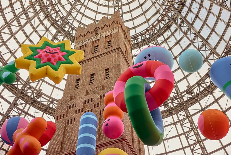 Giant colourful inflatables suspended in the Shot Tower space at Melbourne Central.